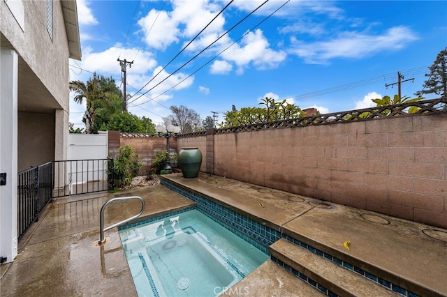 view of pool with an in ground hot tub