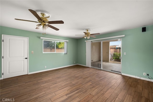 spare room featuring dark wood-type flooring and ceiling fan