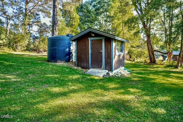 view of outdoor structure featuring a lawn