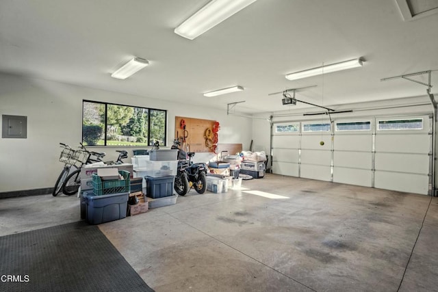 garage with a garage door opener and electric panel