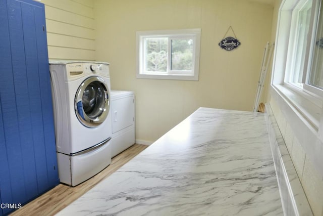 laundry room with hardwood / wood-style flooring and independent washer and dryer