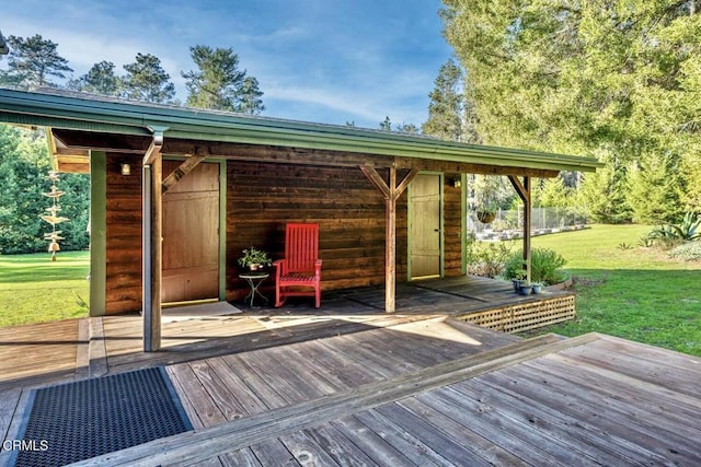 wooden terrace with a lawn