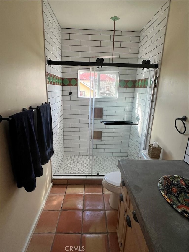 bathroom featuring a shower with door, vanity, tile patterned flooring, and toilet