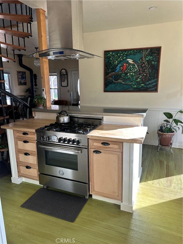 kitchen featuring high end stainless steel range oven, island range hood, dark hardwood / wood-style flooring, and light brown cabinetry