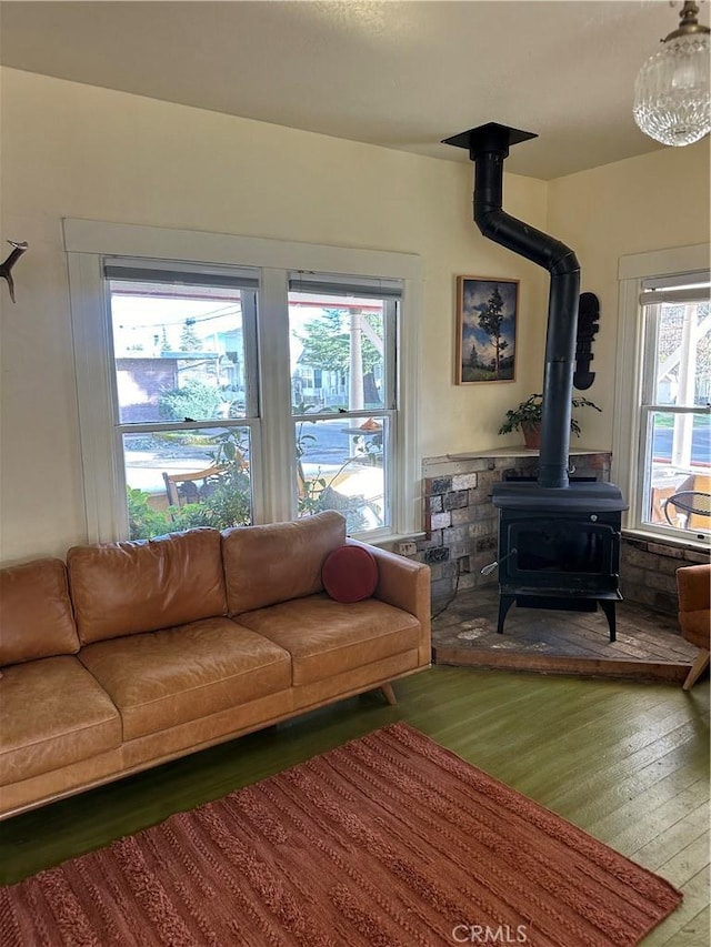 living room with wood-type flooring and a wood stove