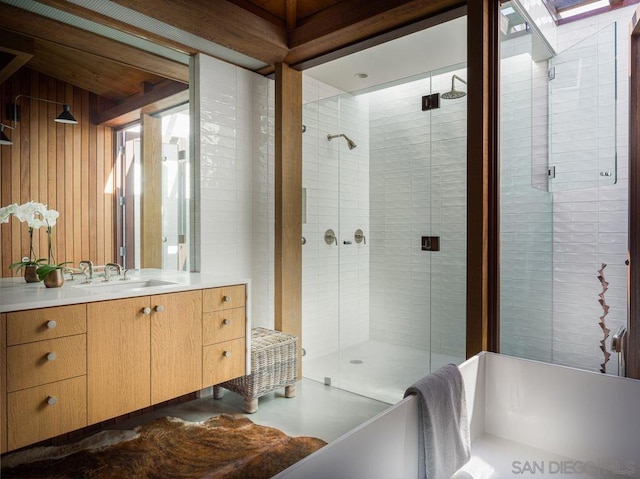 bathroom featuring vanity, wooden walls, and an enclosed shower