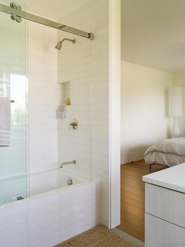 bathroom featuring combined bath / shower with glass door