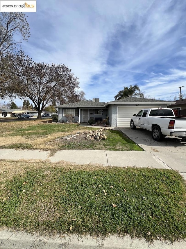 view of front facade with a garage and a front lawn