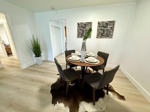 dining space with light hardwood / wood-style flooring