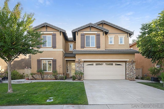 craftsman house featuring a garage and a front yard