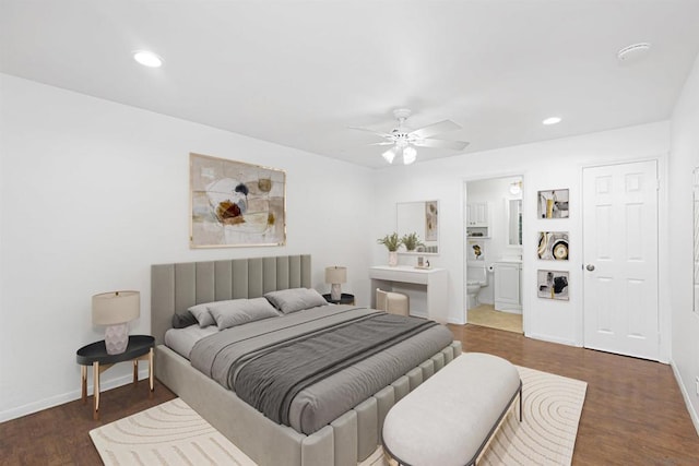 bedroom with ensuite bath, dark wood-type flooring, and ceiling fan