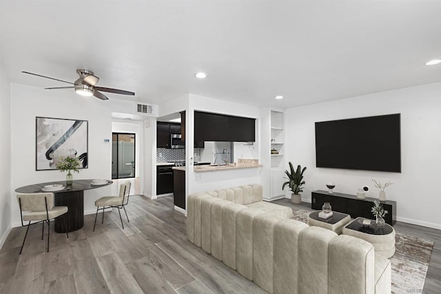 living room featuring ceiling fan and light wood-type flooring