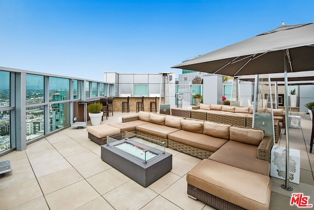 view of patio featuring an outdoor living space with a fire pit