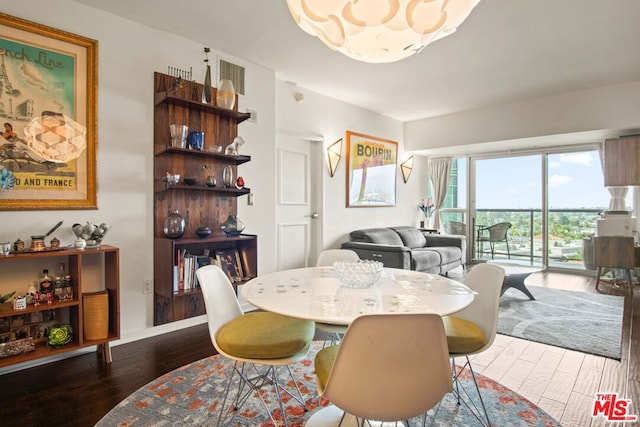 dining space with dark hardwood / wood-style floors