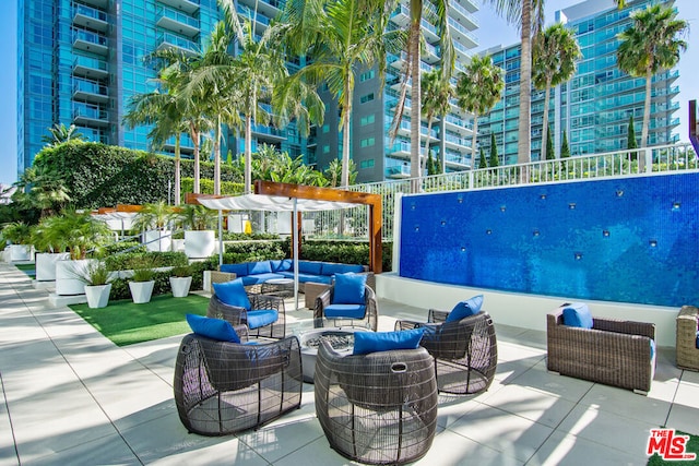 view of pool featuring an outdoor hangout area, a pergola, and a patio