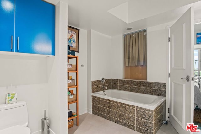 bathroom with tiled bath and toilet