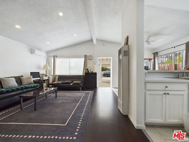 living room with a healthy amount of sunlight, dark hardwood / wood-style floors, a wall mounted AC, and vaulted ceiling with beams