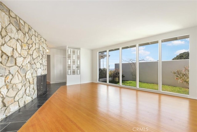 unfurnished living room with dark hardwood / wood-style flooring and a fireplace