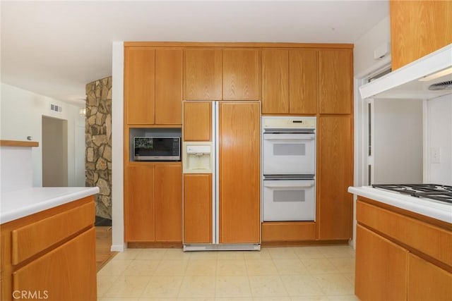 kitchen featuring double oven and paneled refrigerator