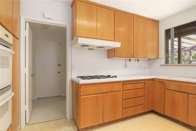 kitchen featuring sink, gas cooktop, and white double oven