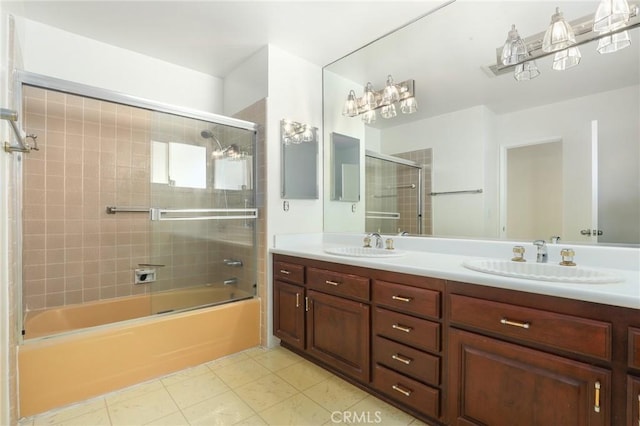 bathroom featuring tile patterned flooring, vanity, and shower / bath combination with glass door