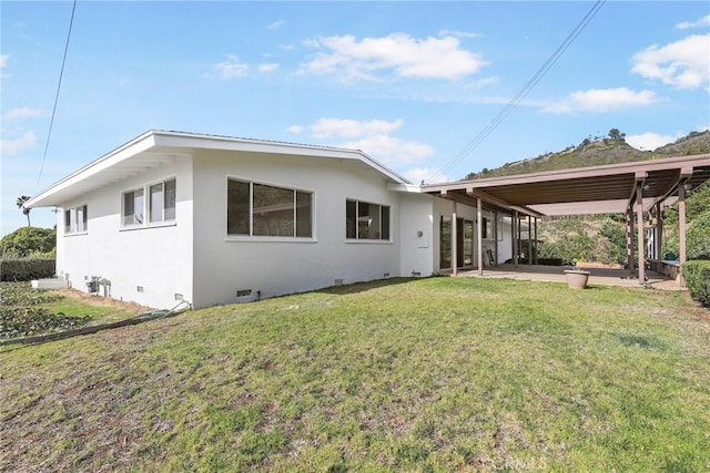 back of property featuring a yard and a patio area