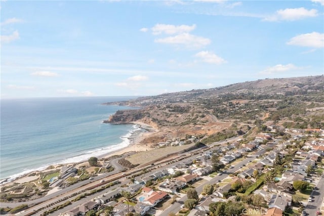 aerial view with a water view and a view of the beach