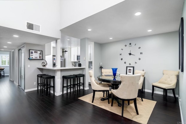 dining room with dark hardwood / wood-style floors