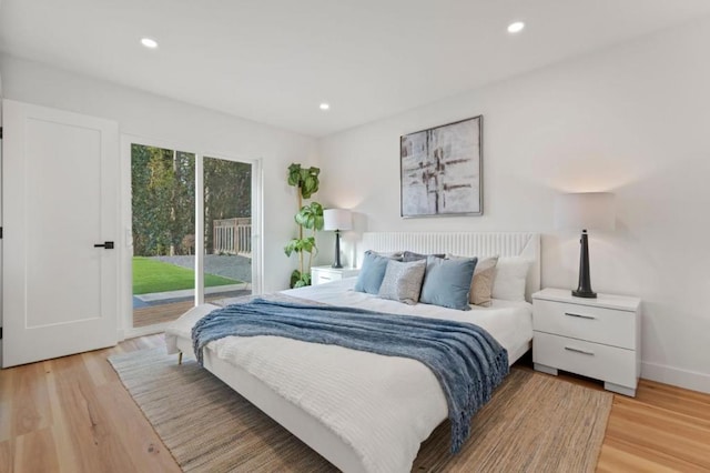 bedroom with access to exterior and light wood-type flooring