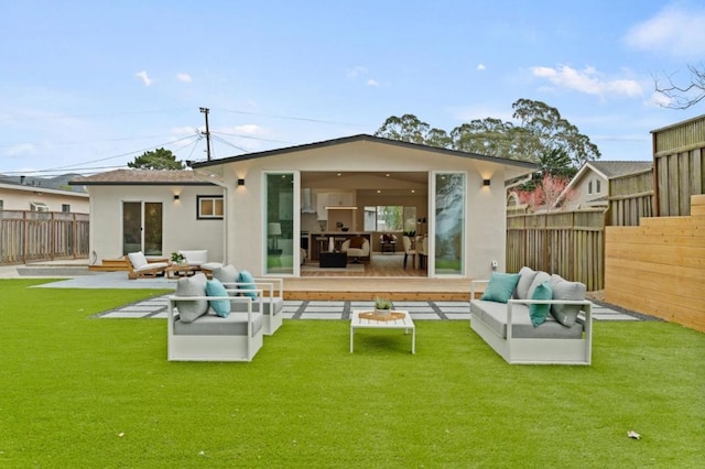 rear view of property featuring an outdoor living space, a lawn, and a patio