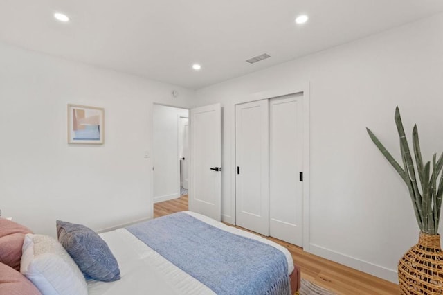 bedroom featuring light hardwood / wood-style floors and a closet