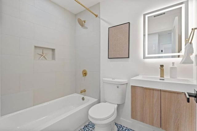 full bathroom with vanity, tiled shower / bath, and toilet