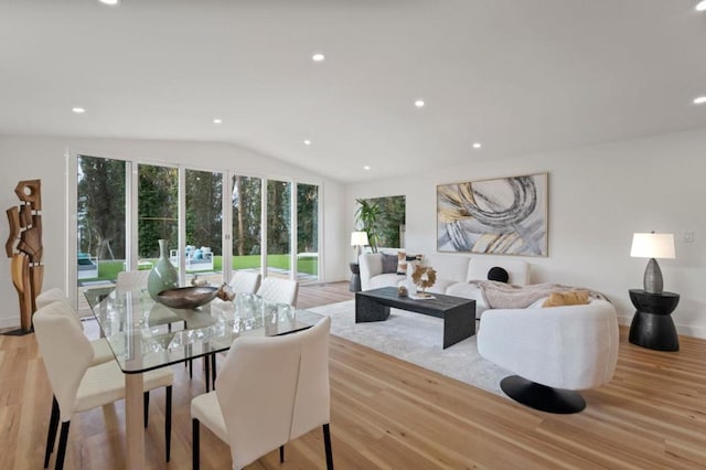 living room featuring vaulted ceiling and light hardwood / wood-style floors