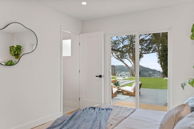 bedroom featuring a mountain view and access to exterior