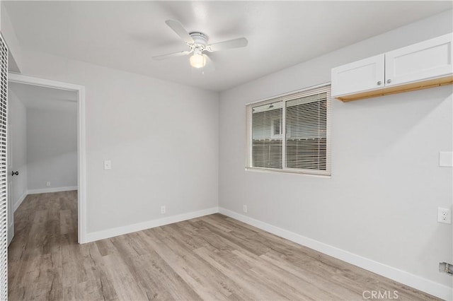 spare room with light hardwood / wood-style floors and ceiling fan