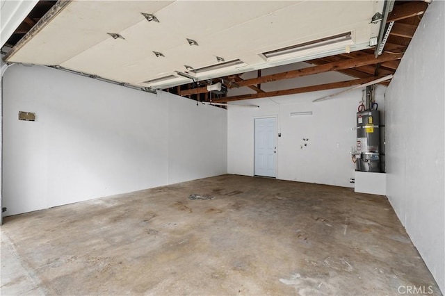 garage featuring a garage door opener and strapped water heater