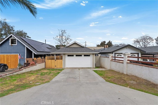 ranch-style home featuring a garage and solar panels