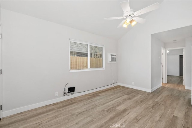 unfurnished room featuring ceiling fan, lofted ceiling, a wall mounted AC, and light wood-type flooring