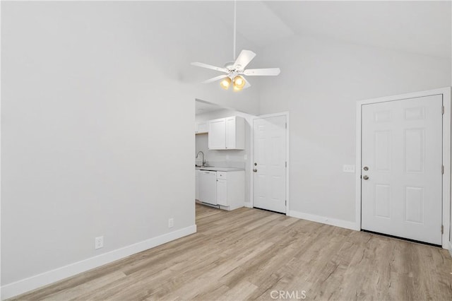 unfurnished living room featuring ceiling fan, high vaulted ceiling, and light hardwood / wood-style floors