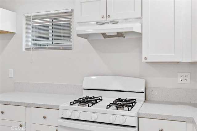 kitchen featuring white cabinetry and gas range gas stove