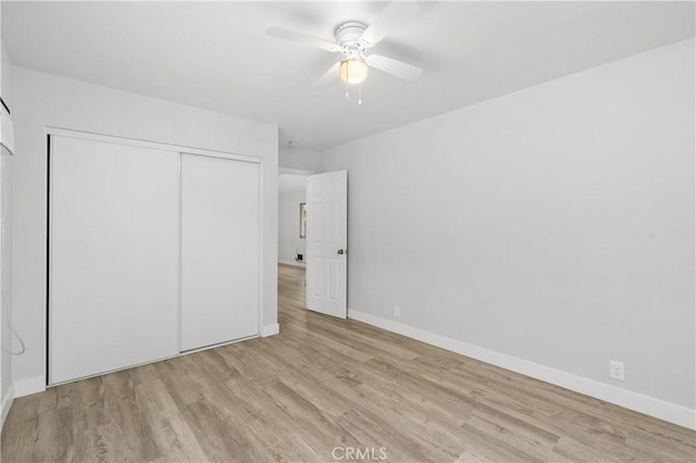 unfurnished bedroom with a closet, ceiling fan, and light hardwood / wood-style flooring