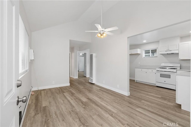 kitchen with white range with gas stovetop, high vaulted ceiling, ceiling fan, light hardwood / wood-style floors, and white cabinets