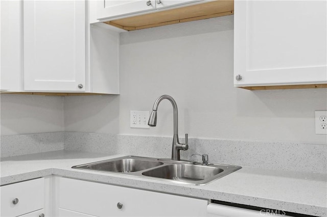 kitchen with white cabinetry and sink