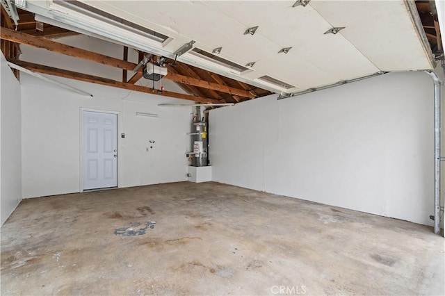 garage featuring secured water heater and a garage door opener