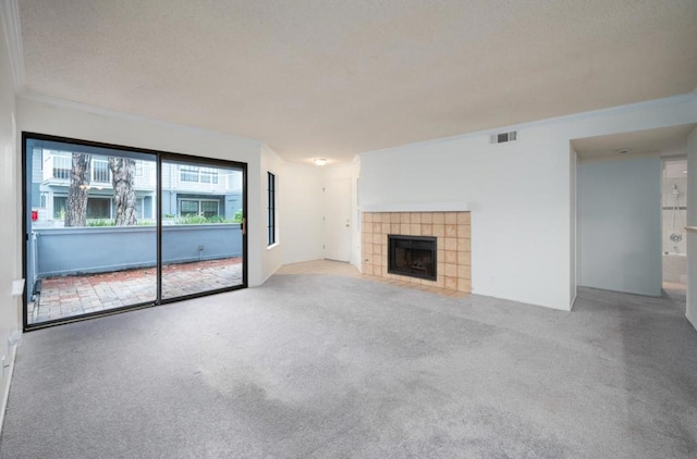 unfurnished living room with crown molding, a fireplace, and carpet floors