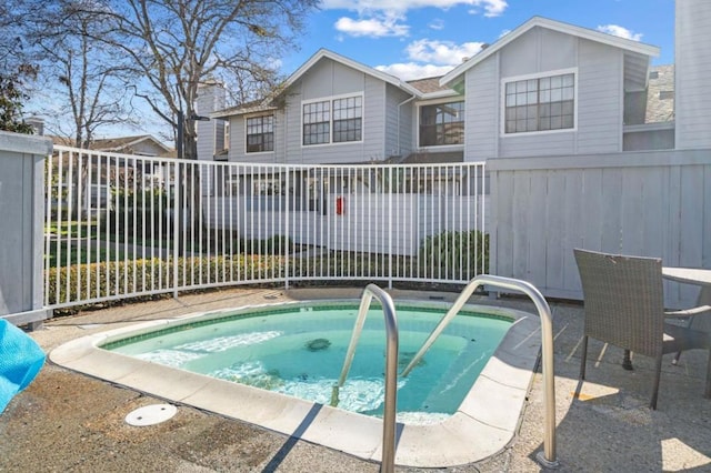 view of swimming pool featuring an in ground hot tub