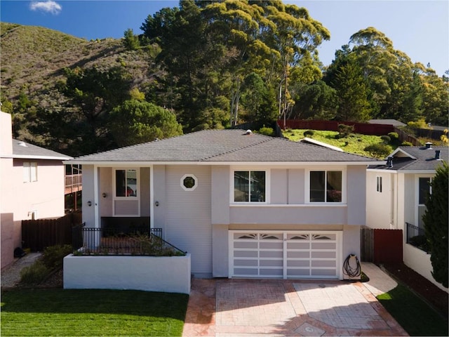 view of front of property featuring a garage and a mountain view