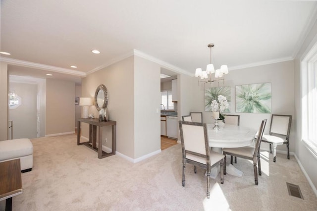 dining area with light carpet, a wealth of natural light, ornamental molding, and a chandelier