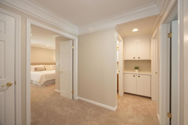 hallway featuring light carpet and crown molding