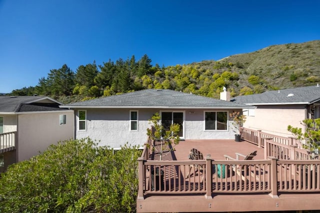 back of property featuring a deck